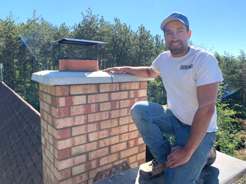 Mason Ryan Smyth, next to a chimney he repaired.